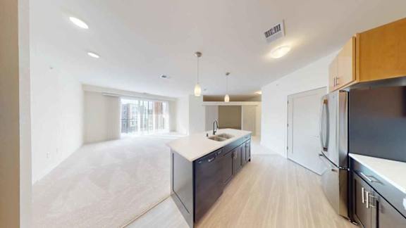 A modern kitchen with wooden cabinets and a large island.