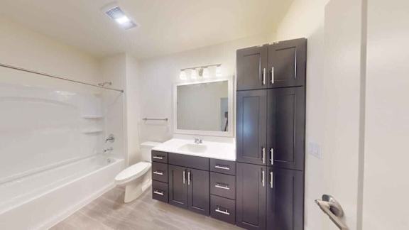 A bathroom with a sink, toilet, and bathtub.