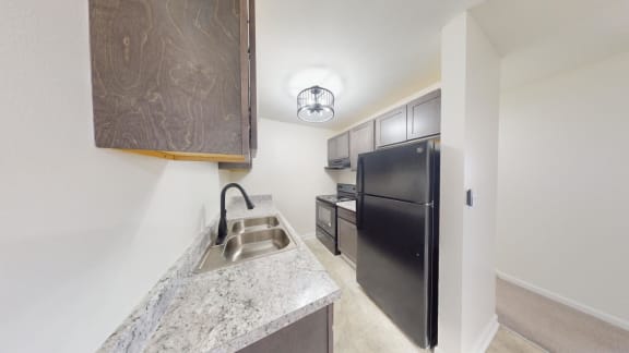 a kitchen with a sink and a refrigerator