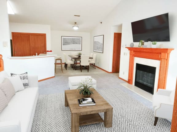 a living room with a couch and a table and a fireplace
