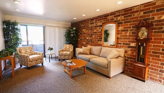 a living room with a brick wall and a couch