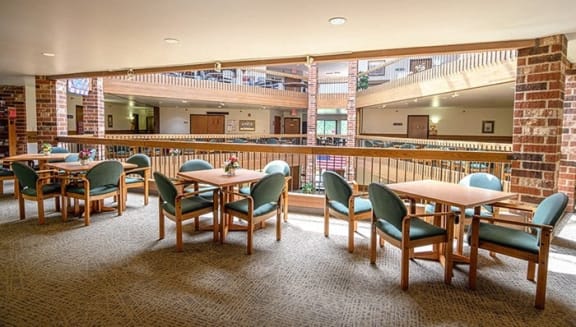 a dining room with tables and chairs and a large window