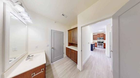 A bathroom with a vanity and a mirror is shown.