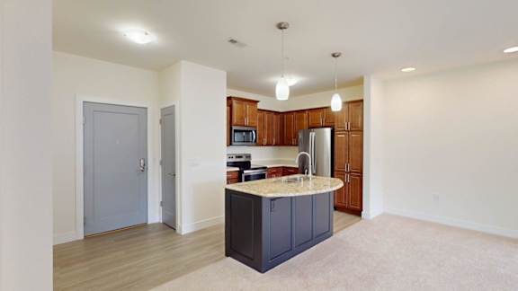 A kitchen with a sink, stove, and cabinets.