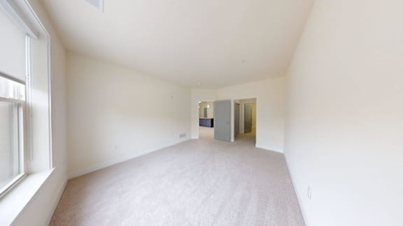 A room with a carpeted floor and white walls.