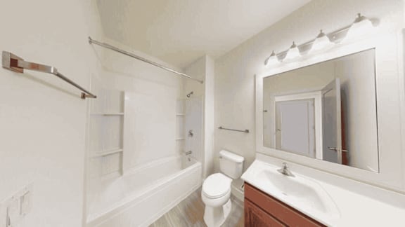 A white bathroom with a toilet, sink, and bathtub.