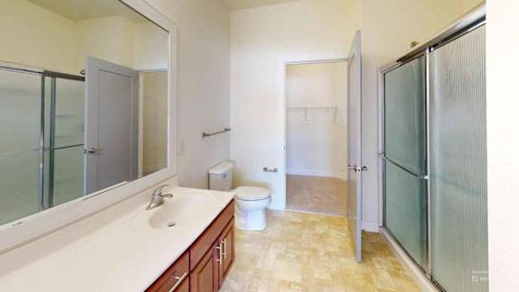 A bathroom with a sink, toilet, and shower.