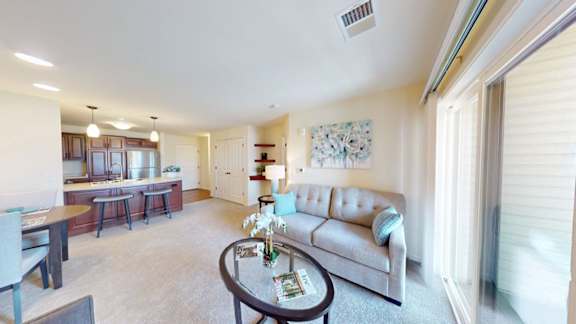 A living room with a grey couch and a coffee table.