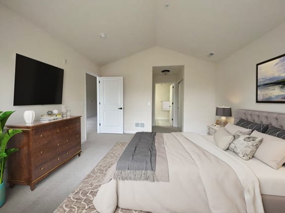 a bedroom with a large bed and a tv