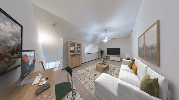 A living room with a white couch and a painting on the wall.