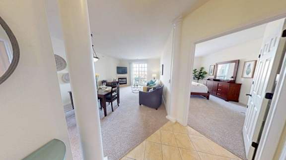 A living room with a couch, a chair, and a television.