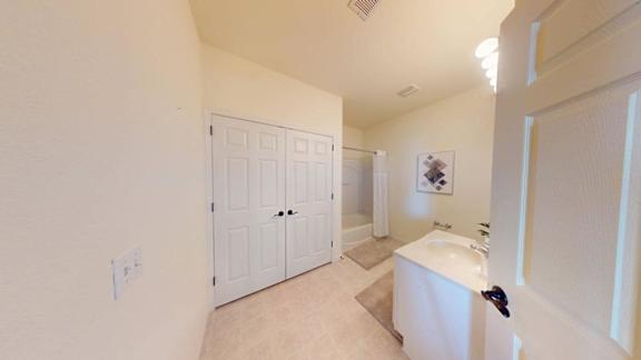 A white bathroom with a sink and a toilet.