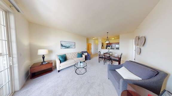 A living room with a grey couch and a wooden coffee table.