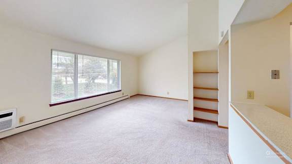 Empty room with a window and a staircase.