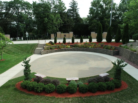 the stage of the amphitheatre is in the middle of a garden