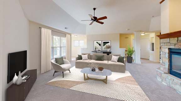 a living room with a couch and a ceiling fan