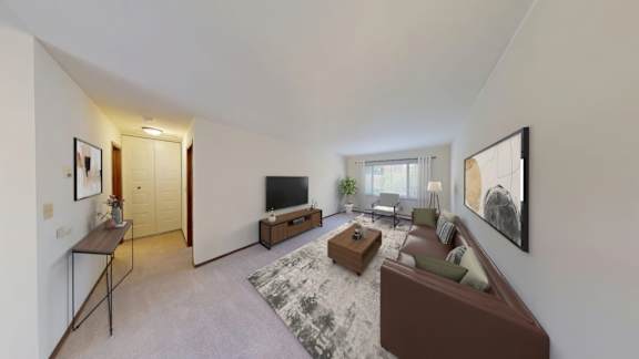 A living room with a brown couch and a television.