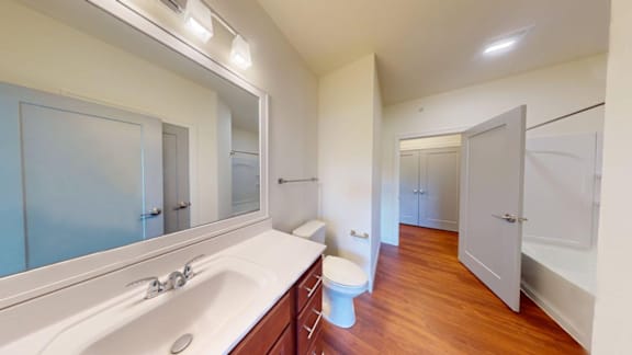 A bathroom with a white sink and a toilet.