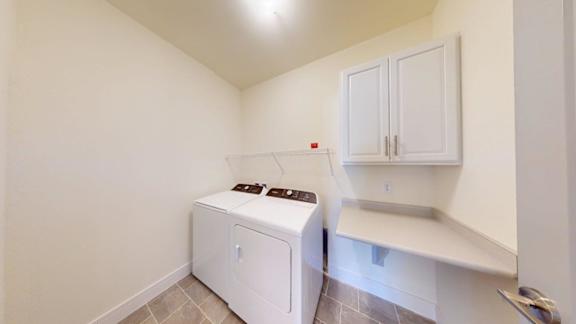 A small white laundry room with a washer and dryer.