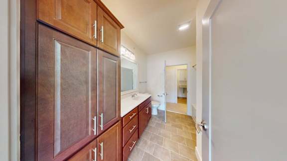 A kitchen with wooden cabinets and a tiled floor.