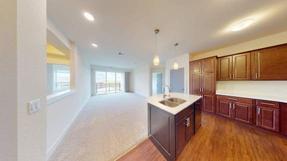 A kitchen with wooden cabinets and a white countertop.