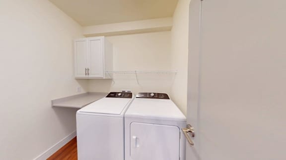 A small laundry room with a washer and dryer.