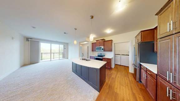 A kitchen with wooden cabinets and a white countertop.