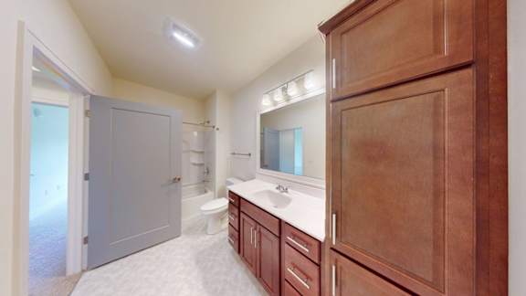 A bathroom with a sink, toilet, and bathtub.