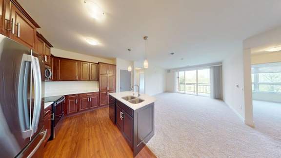 A kitchen with wooden cabinets and a refrigerator.