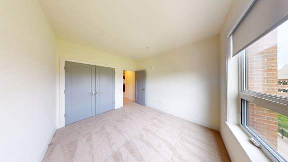 A room with a window and a door.