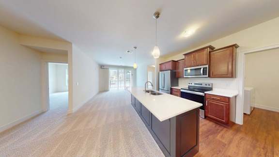 A kitchen with wooden cabinets and a white countertop.