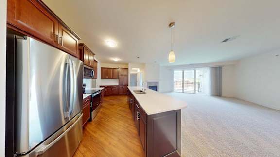 A modern kitchen with wooden cabinets and stainless steel appliances.