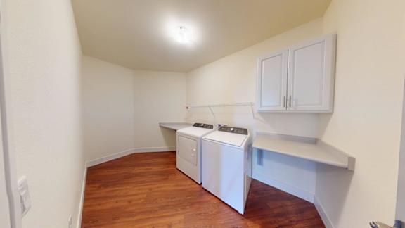 A small laundry room with a washer and dryer.