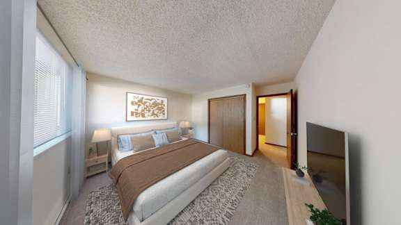 A bedroom with a large bed and a television.