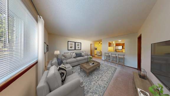 A living room with a grey couch and a coffee table.