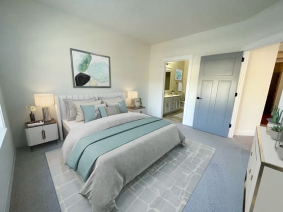 a bedroom with a bed and a door to a bathroom