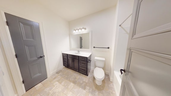 a bathroom with a toilet and a sink and a mirror