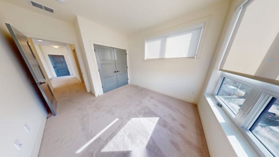 an empty room with a door and a window