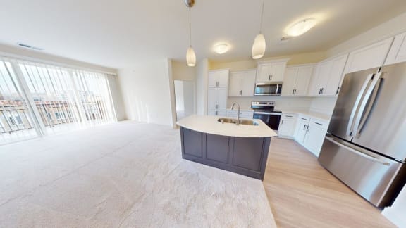 a kitchen and living room with stainless steel appliances