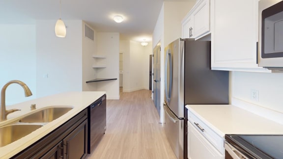 a kitchen with a sink and a refrigerator