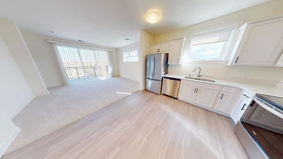 an empty kitchen and living room in a house