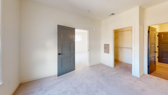 an empty room with a blue door in the middle of it