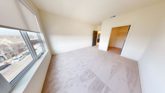 an empty living room with a large window