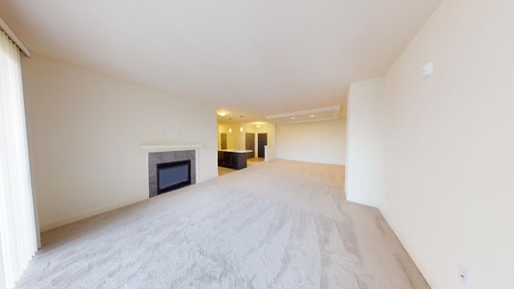 the living room and dining room of a house with a fireplace