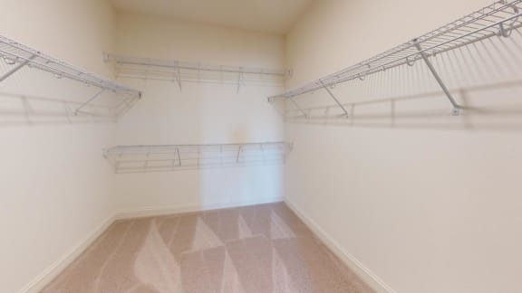 an empty room with white walls and shelves on the wall
