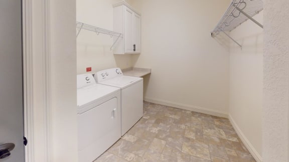 a laundry room with a washer and dryer and a closet