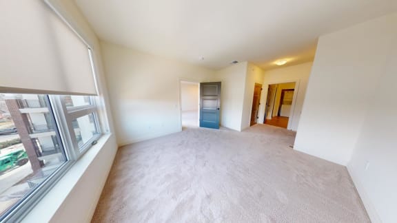 an empty living room with a large window