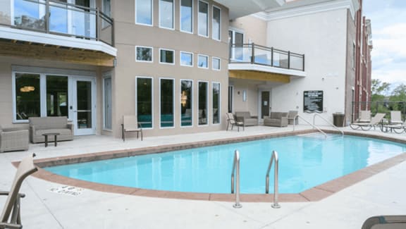 Swimming pool in front of a building  at Poplar Creek Apartments, Brookfield, WI, 53045