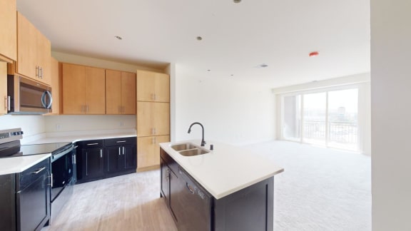 a kitchen with black appliances and a white counter top