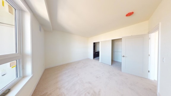 a empty room with white walls and a window